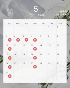 May 2026 calendar with holidays marked by red circles labeled 休 on multiple days, over a light floral background.